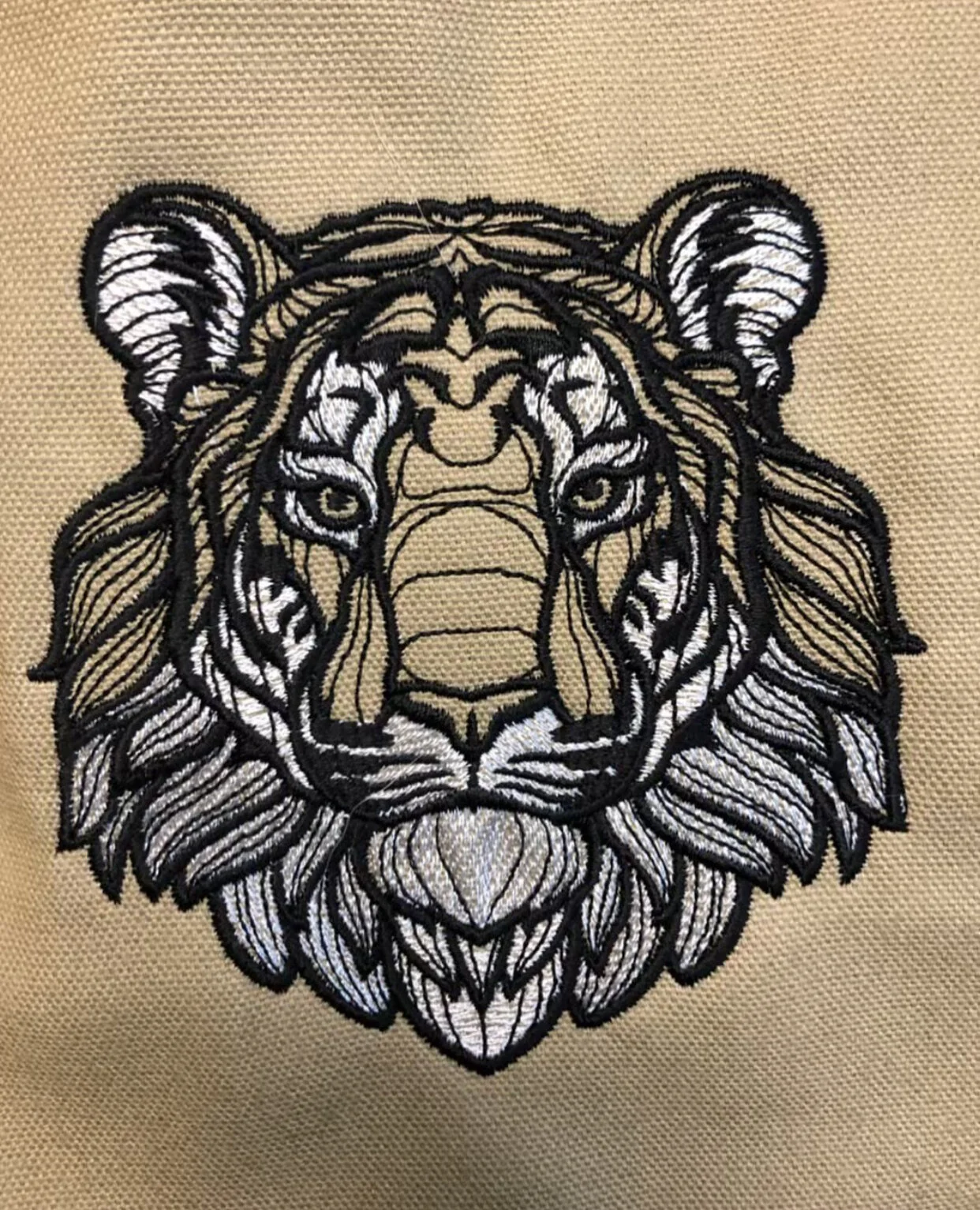 Custom tiger lion face embroidery closeup Colorado ATMOS Printing